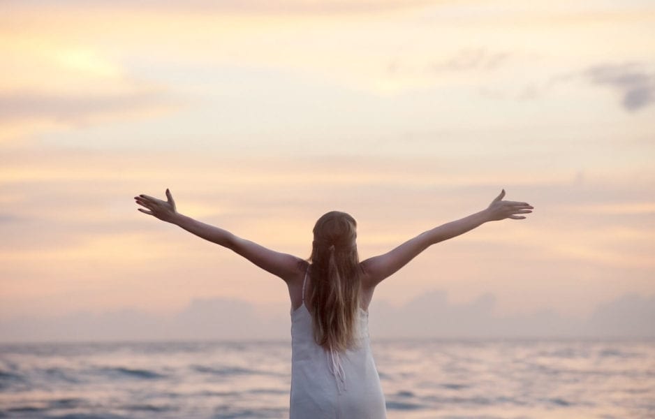 the freedom of solo travel - women with arms outstretched