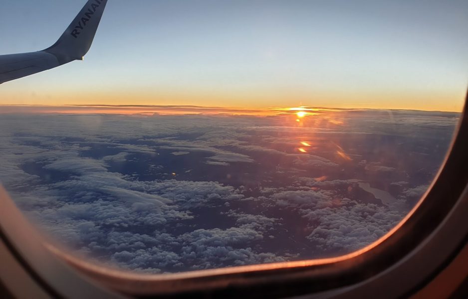 Views of a sunset out of an airplane window - some of my favourite views when I travel europe on a budget