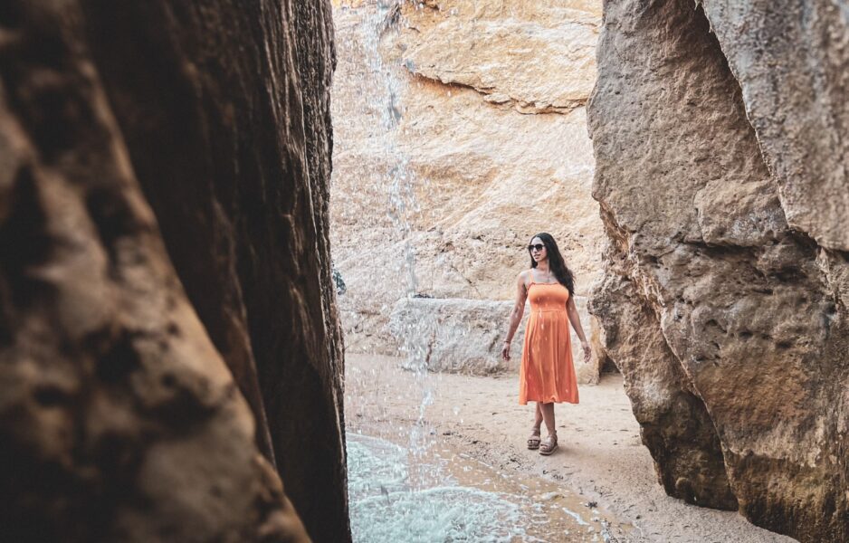 Walking behind the waterfalls at Tamaghza Oasis