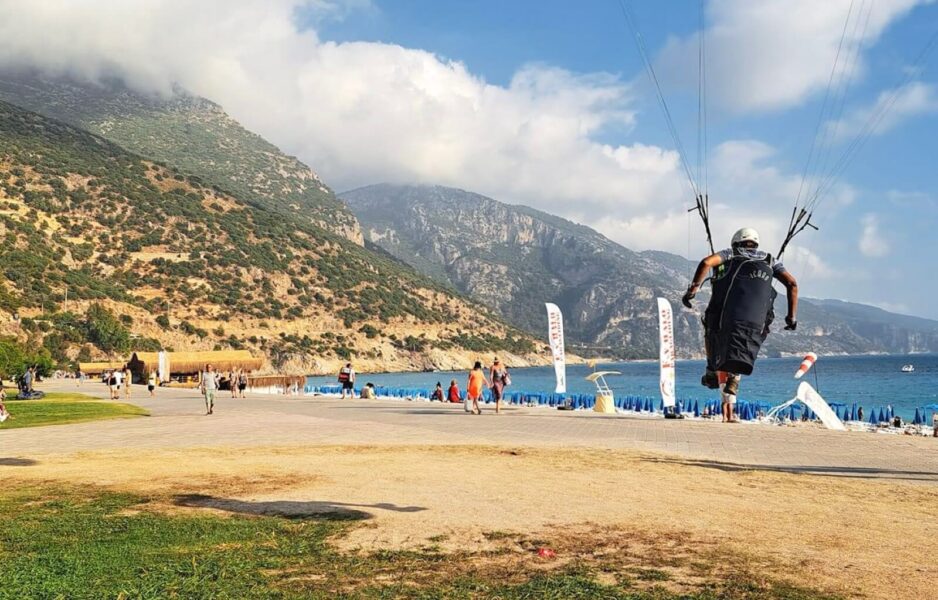 A paraglider landing on the beach in Oludeniz